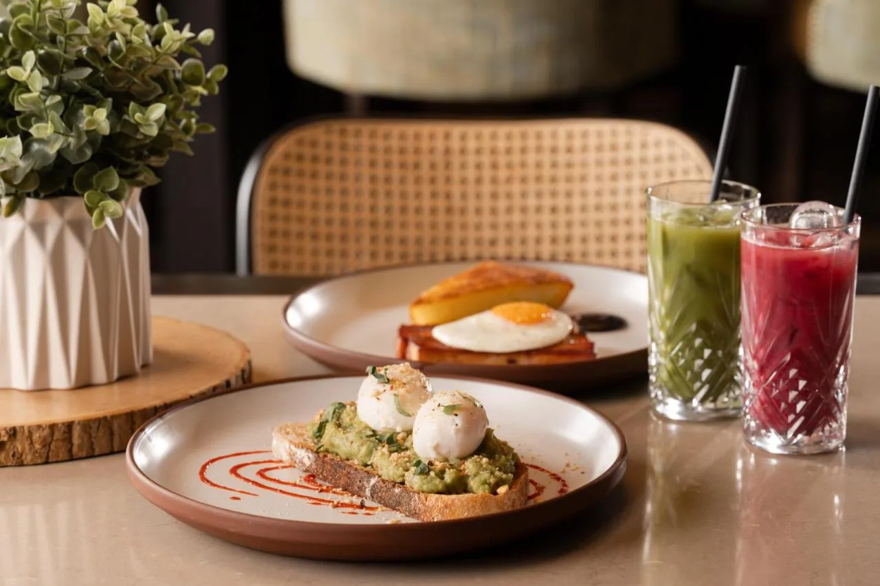 two plates of food on a table with drinks at Grand Central Hotel Belfast in Belfast